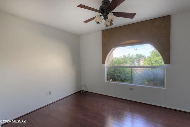 unfurnished room featuring dark hardwood / wood-style flooring and ceiling fan