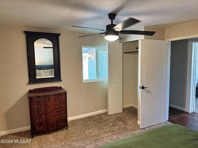 unfurnished bedroom with a closet, baseboards, carpet floors, and ceiling fan