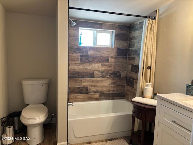 bathroom with vanity, shower / bath combo, and toilet