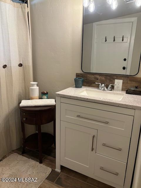 full bath featuring vanity and wood finished floors