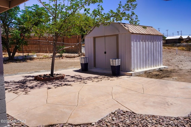 view of shed featuring fence