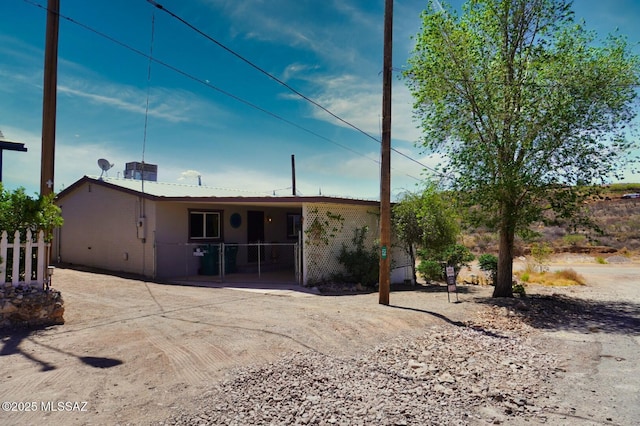 rear view of house with a gate and fence