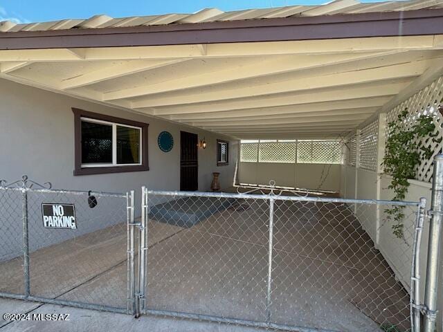 exterior space featuring fence, a gate, and metal roof