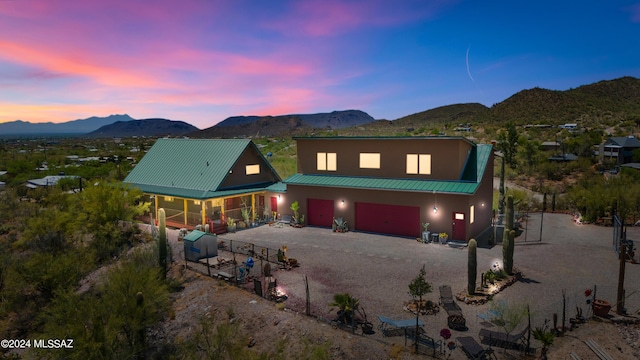 view of front facade with a garage and a mountain view