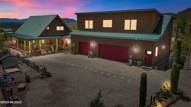 view of front of property featuring covered porch, a garage, and a mountain view