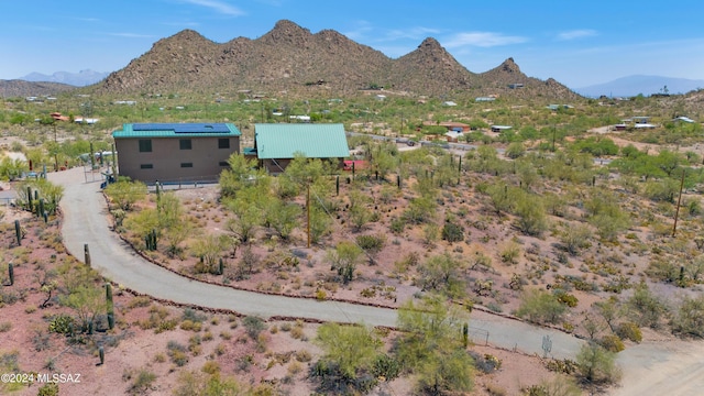 view of front of home with a garage, a porch, and a mountain view