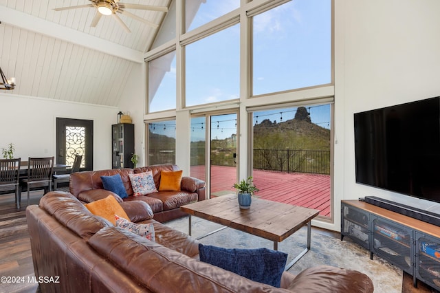 living room featuring high vaulted ceiling and dark wood-type flooring