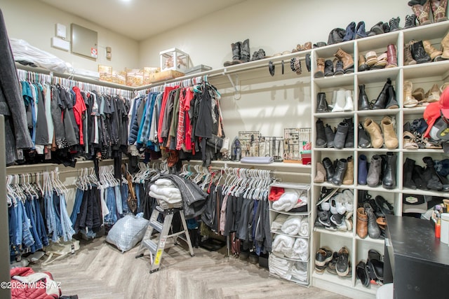 spacious closet featuring parquet flooring