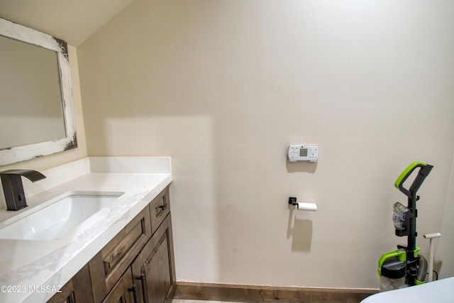 bathroom featuring vanity and vaulted ceiling