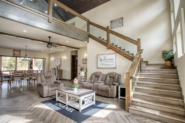 living room featuring ceiling fan, beam ceiling, parquet floors, and high vaulted ceiling