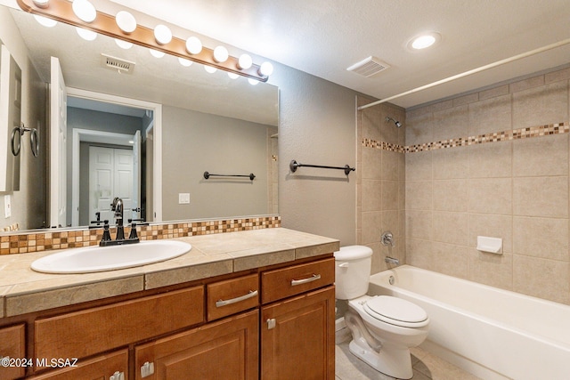 full bathroom with vanity, toilet, tiled shower / bath, and tasteful backsplash