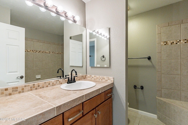 bathroom with tile patterned floors, decorative backsplash, and vanity