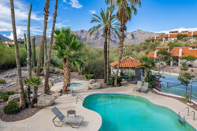 view of swimming pool featuring a gazebo, a mountain view, and a patio