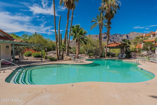 view of pool with a mountain view, a patio, and a pergola