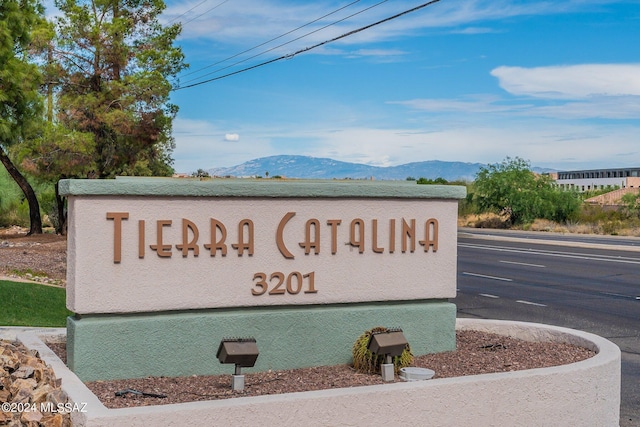 community sign with a mountain view