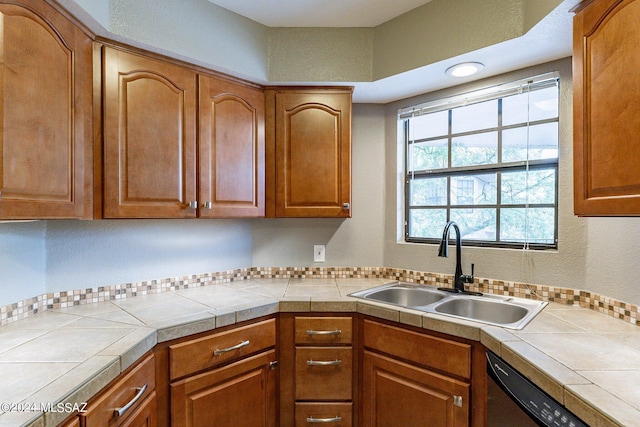 kitchen featuring dishwasher, tile countertops, and sink