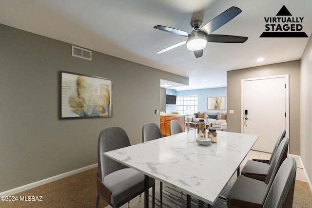 dining room with carpet flooring and ceiling fan