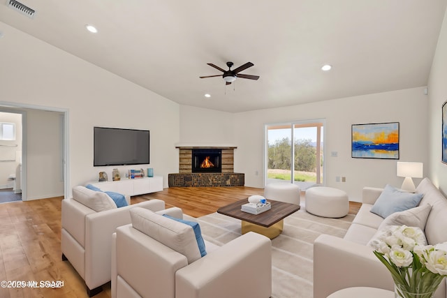 living room featuring light wood-type flooring, recessed lighting, visible vents, lofted ceiling, and ceiling fan