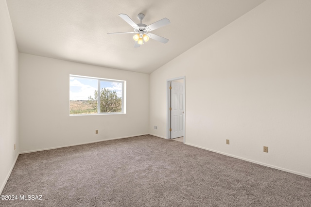 spare room featuring carpet floors, lofted ceiling, and ceiling fan