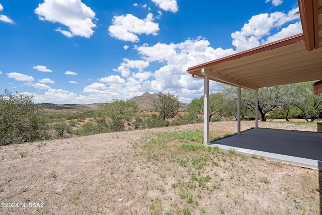 view of yard featuring a patio area and a mountain view