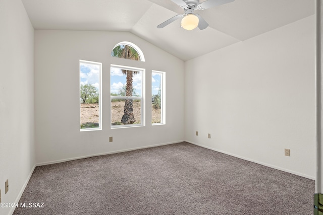 carpeted empty room featuring baseboards, a ceiling fan, and vaulted ceiling