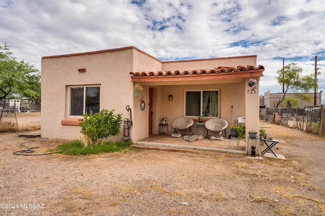 rear view of property featuring a patio