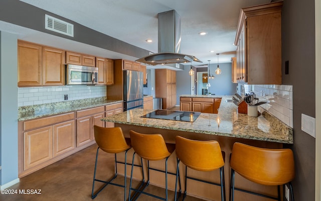 kitchen with kitchen peninsula, decorative backsplash, island exhaust hood, light stone countertops, and appliances with stainless steel finishes