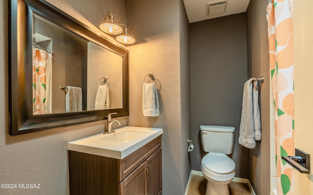 bathroom featuring toilet and vanity