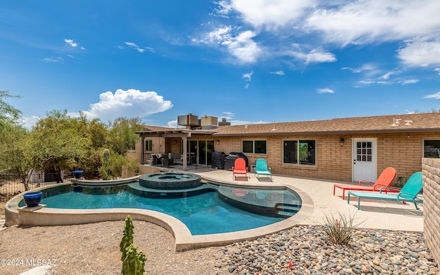 view of swimming pool featuring a patio area, central air condition unit, and an in ground hot tub