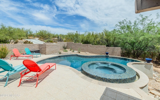 view of pool featuring a patio area and an in ground hot tub