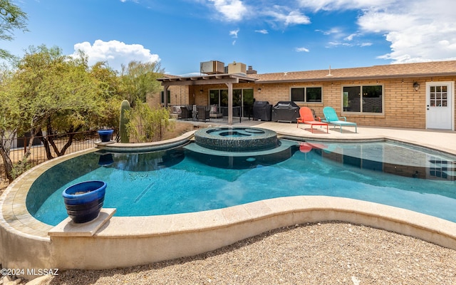 view of swimming pool with area for grilling, an in ground hot tub, and a patio