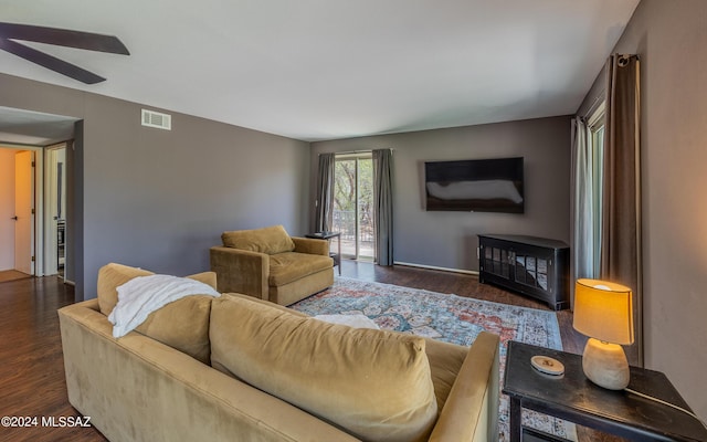 living room with ceiling fan and dark hardwood / wood-style flooring