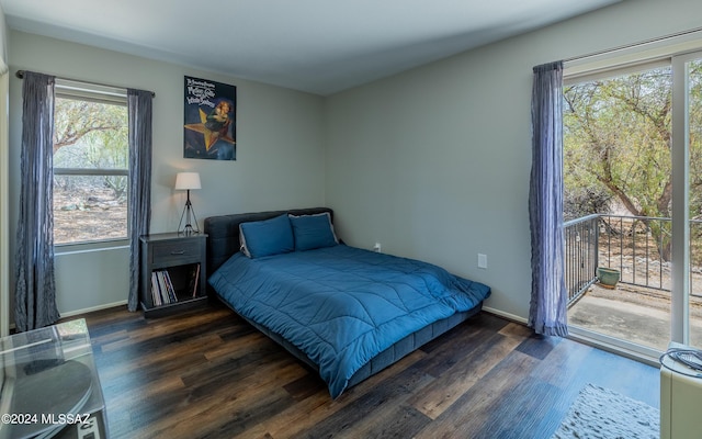 bedroom featuring access to exterior and dark wood-type flooring