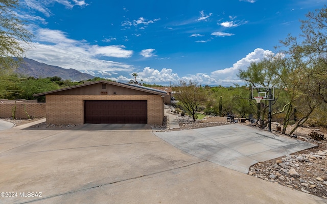 view of front of property with a garage and a mountain view