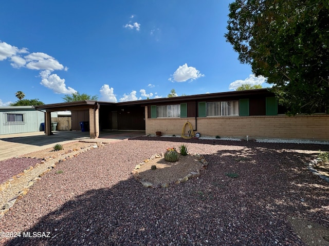 ranch-style home featuring a carport