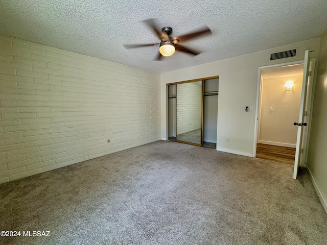 unfurnished bedroom with ceiling fan, a closet, carpet floors, and a textured ceiling