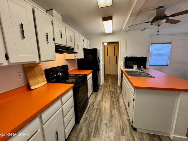 kitchen featuring white cabinetry, sink, black appliances, and light hardwood / wood-style floors