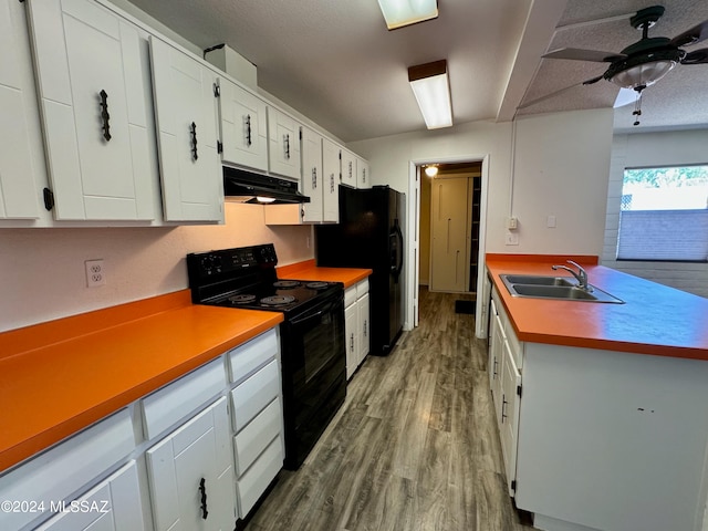 kitchen featuring black appliances, light hardwood / wood-style floors, white cabinets, and sink