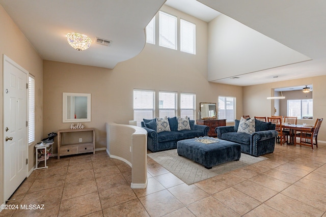 tiled living room featuring ceiling fan