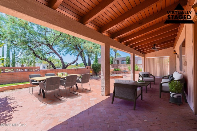 view of patio featuring ceiling fan, outdoor dining space, and a fenced backyard