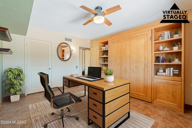 office with a ceiling fan, visible vents, a textured ceiling, and light tile patterned flooring