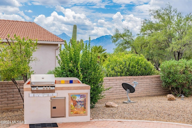 view of patio / terrace with a mountain view and exterior kitchen