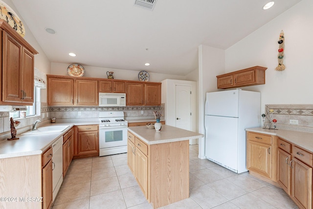 kitchen with a center island, sink, backsplash, white appliances, and light tile patterned floors