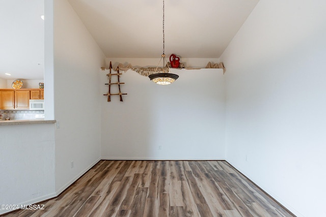 unfurnished dining area with hardwood / wood-style flooring