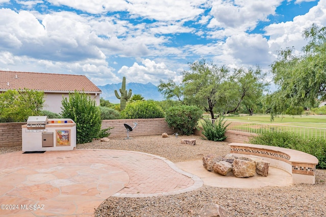 view of patio featuring an outdoor kitchen and a mountain view