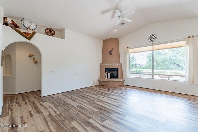 unfurnished living room featuring a fireplace, hardwood / wood-style floors, ceiling fan, and lofted ceiling