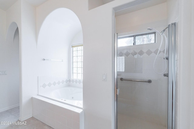 bathroom with shower with separate bathtub