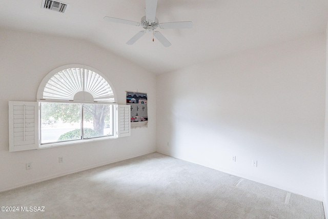 carpeted empty room with vaulted ceiling and ceiling fan