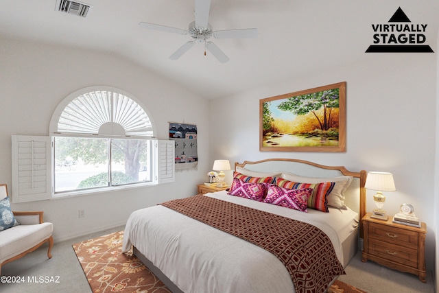 carpeted bedroom with ceiling fan and lofted ceiling