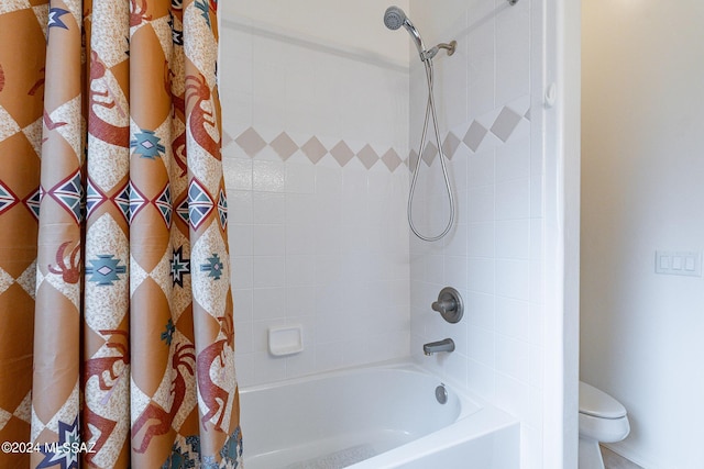 bathroom featuring shower / tub combo with curtain and toilet